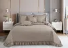 A neatly made bed with taupe bedding in a bedroom setting. Produktbild-Vorschau