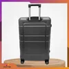 A gray suitcase is displayed on a wooden platform against a white background with abstract wavy lines. Náhled obrázku produktu