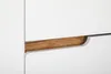 A close-up view of a white cabinet with a wooden accent. Podgląd zdjęcia produktu