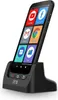 A black smartphone is docked in a black charging cradle. The phone's screen displays several app icons. Voir les images du produit