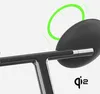 A close-up of a black and silver device, possibly a charger or stand, with a green circular graphic indicating wireless charging. Produktbild-Vorschau