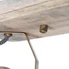 A close-up view of a wooden surface with a brass fixture and a black and white patterned cord. Produktbild-Vorschau