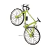 A miniature green bicycle ornament is shown against a white background. Produktbild-Vorschau