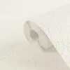 A roll of white textured wallpaper is shown in close-up, with the roll angled and partially unrolled. Produktbild-Vorschau
