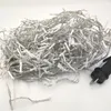 A tangled pile of white LED string lights with a black power plug on a white background. Produktbild-Vorschau