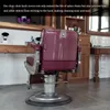 A salon chair with a clear protective cover on its back, in a salon setting. Produktbild-Vorschau