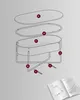 An exploded diagram showing the assembly of a baby bassinet, with labels pointing to different parts, next to an open instruction manual. Náhled obrázku produktu