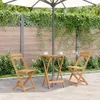 A wooden folding table and two chairs are set up on a patio under a large umbrella, surrounded by greenery. Anteprima dell’immagine prodotto