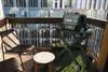 A grill stand on a balcony with a city view. Náhľad obrázku produktu