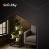 A living room scene with a chair and plant stands. Podgląd zdjęcia produktu