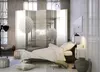 A bedroom scene with a bed, a room divider, and decorative items. Produktbild-Vorschau