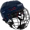 A dark blue CCM hockey helmet with a black cage is shown from a three-quarter angle against a white background. Náhľad obrázku produktu