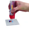 A hand holding a bead dispenser over a pegboard with beads. Náhled obrázku produktu