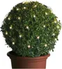 A potted, spherical topiary bush decorated with warm white LED string lights. Produktbild-Vorschau