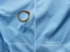 A split image showing a blue fabric with stains on the left side and the same fabric after washing on the right side. Voir les images du produit