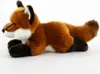 A plush toy fox lying down on a white background. Produktbild-Vorschau