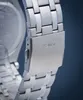 A close-up shot of a watch clasp with the brand name 'GUESS' engraved on it. Náhled obrázku produktu