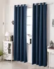 A room interior with dark blue curtains covering a window, a white dresser with decorative items, and a lamp. Produktbild-Vorschau