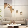 A modern living room with a sectional sofa, coffee table, and pendant lights. Podgląd zdjęcia produktu