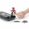 A hand is shown interacting with a Nintendo Wii U gamepad, with a Mario amiibo figure placed on the gamepad's NFC touchpoint. Produktbild-Vorschau