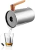 A kettle pouring hot water into a glass with a tea bag. Anteprima dell’immagine prodotto