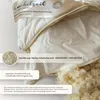 A close-up view of a pillow with its filling exposed, showing the texture of the material and the filling. Produktbild-Vorschau