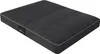 A dark gray dog bed with white piping, shown from a slightly elevated angle on a white background. A small black label with red and white text is visible on the left side of the bed. Anteprima dell’immagine prodotto