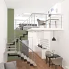 A multi-level interior space with stairs, a kitchen area, and a dining set. Produktbild-Vorschau