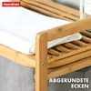 Close-up of a bamboo laundry basket with a folded white towel on one of its shelves. Anteprima dell’immagine prodotto