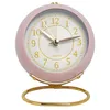 A pink analog alarm clock with a gold stand. Produktbild-Vorschau