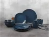 A dark blue stoneware dinnerware set is arranged on a gray surface against a textured gray background. Produktbild-Vorschau