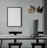 A modern dining room setting with a concrete-effect planter and dried flowers on a rustic table. Produktbild-Vorschau