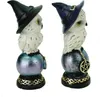 Two decorative owl figurines wearing witch hats, each sitting on a sphere. Produktbild-Vorschau