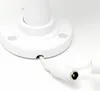 A close-up view of the base of a white camera mount with a white power cable plugged into it. Produktbild-Vorschau
