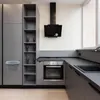 A modern kitchen with gray cabinets and a black range hood. Produktbild-Vorschau