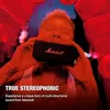 A person holding a Marshall speaker to their face, with red lighting. Produktbild-Vorschau