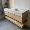 A modern double sink vanity with a stone countertop and wooden drawers, mounted on a wall with a shelf below. Anteprima dell’immagine prodotto