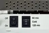 Close-up of the control panel of a laminating machine, showing two switches and text labels. Voir les images du produit