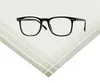 A pair of black-rimmed glasses is placed on top of a folded white handkerchief with green stripes. Produktbild-Vorschau