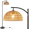 A floor lamp with a woven shade and a black metal stand. Podgląd zdjęcia produktu
