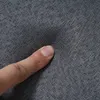 A close-up of a finger pressing into a textured gray fabric. Produktbild-Vorschau