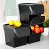 A kitchen counter with stacked black storage containers for fruits and vegetables. Anteprima dell’immagine prodotto