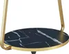 A close-up view of a round table with a black marble-like top and gold legs. Podgląd zdjęcia produktu