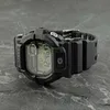 A black Casio G-Shock watch is displayed on a textured gray surface. Produktbild-Vorschau