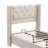 A close-up view of the headboard and frame of a beige upholstered bed. Náhled obrázku produktu