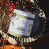 A jar of pistachio cream is placed on a decorative metal tray, surrounded by red berries and branches. Produktbild-Vorschau