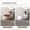 Two bathroom sinks, one in pale beige and one in white, displayed side-by-side on a textured counter. Anteprima dell’immagine prodotto