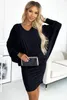 A woman is posing in a black dress, holding a clutch. Anteprima dell’immagine prodotto