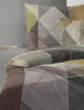 A close-up view of a bedding set with a geometric pattern. Produktbild-Vorschau