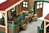 A detailed toy model of a horse stable with two horses and various accessories. Produktbild-Vorschau